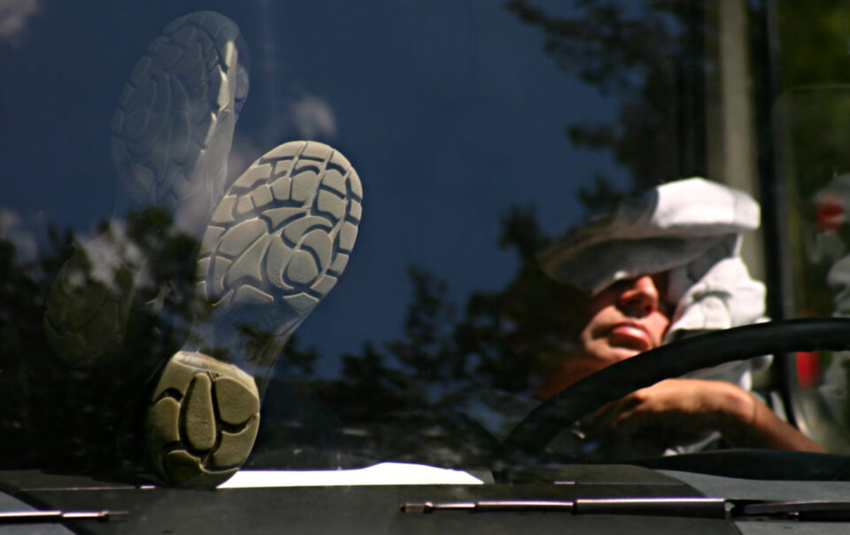 truck driver sleeping in cab of truck