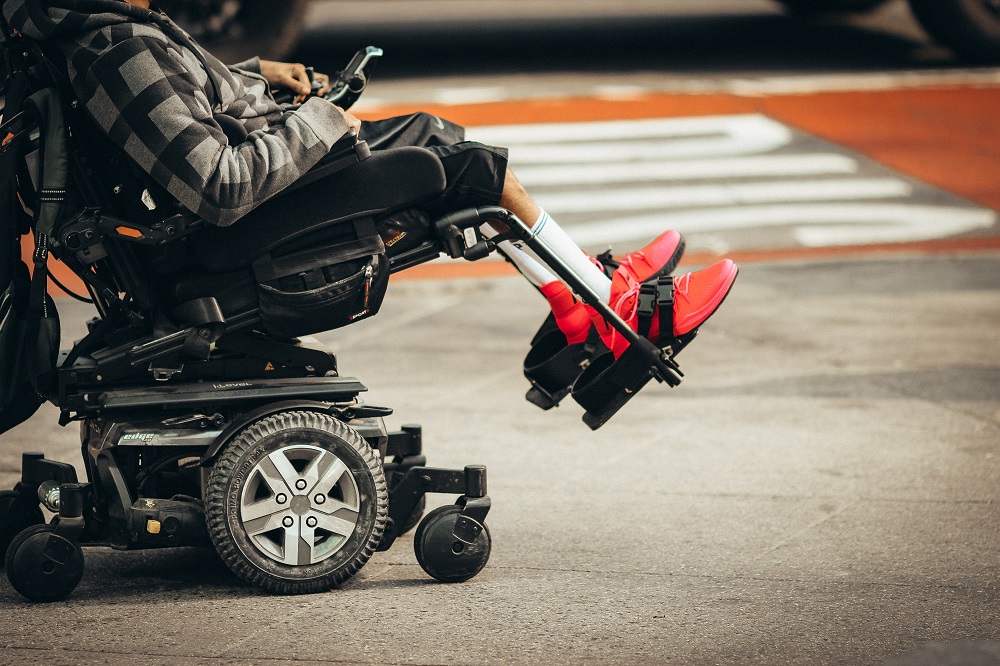 man reclining in a wheelchair neck down