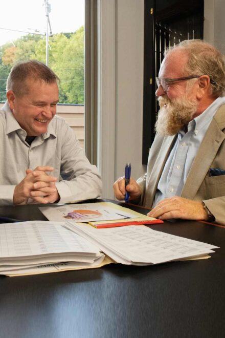 Mike Warren and Aaron McHenry at law firm desk